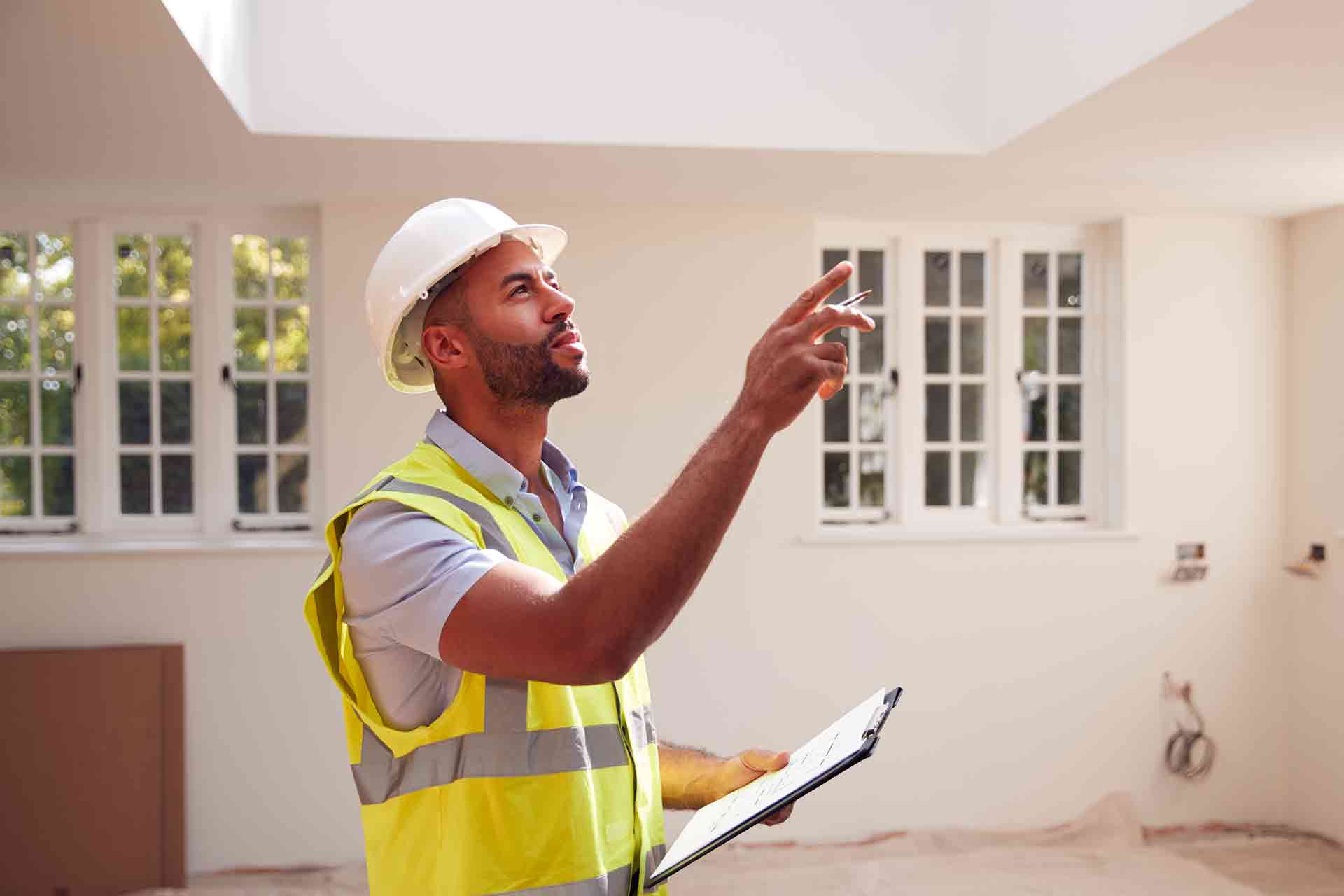 Third Party Wall Surveyors Leeds reviewing plans between two parties during a dispute